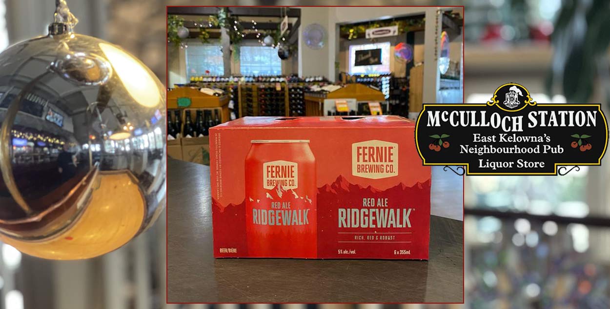 A box displaying  Fernie Red Ale with a blurred back drop of mcCullochs pub.